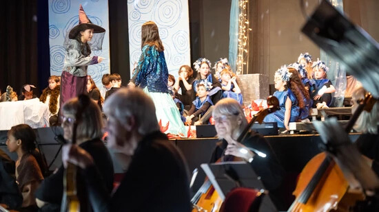Die Hexe verflucht die Quellnymphe: Begleitet vom Orchester Churer Musikfreunde präsentieren Schulkinder des Lachen-Schulhauses ihr Singspiel.